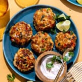 Plate of Tex Mex seasoned crab cakes on a plate served with a creamy sauce.