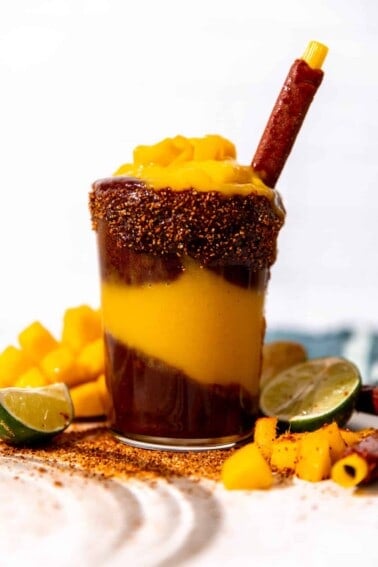 Cup of homemade mangonada served with a tamarindo straw.
