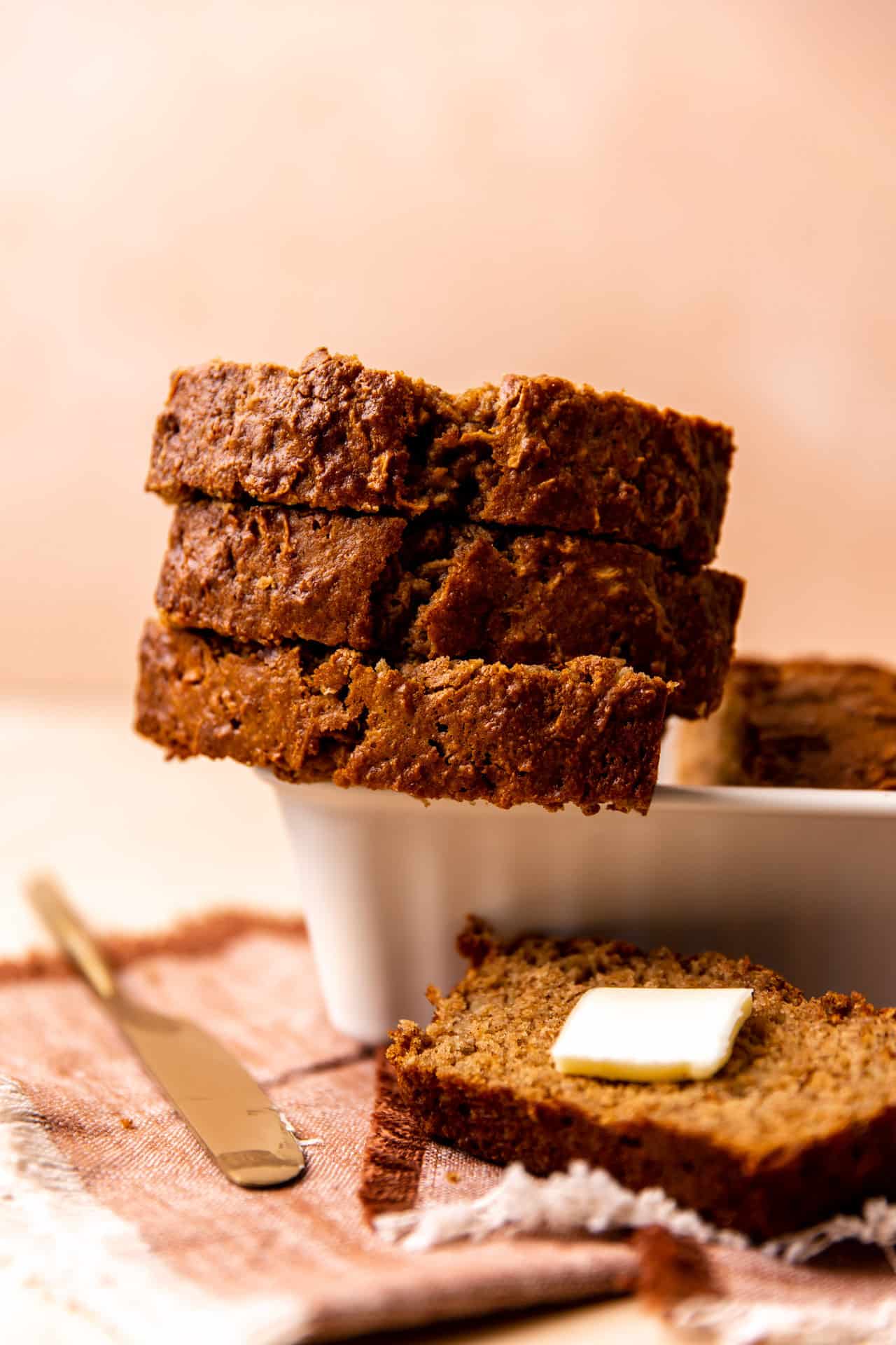 Stack of sliced apple bread on a loaf pan. 