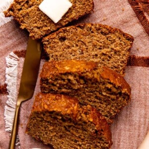 Slices of apple bread laid out with a slab of butter on top.