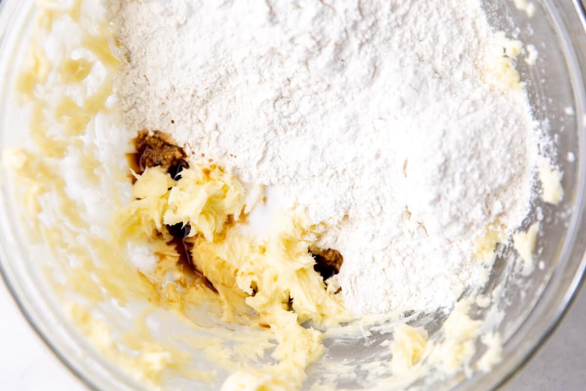 Creamed butter with powdered sugar and vanilla being added. 