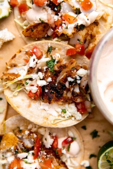 Tortillas filled with cut seasoned and seared cod, cabbage, tomatoes and queso.