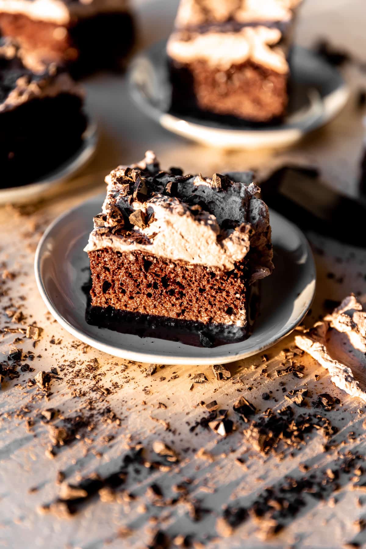 Plates of chocolate tres leches cake on plates. 