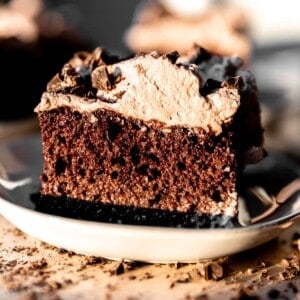 Slice of chocolate tres leches cake on a plate.
