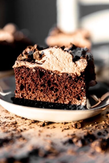 Slice of chocolate tres leches cake on a plate.