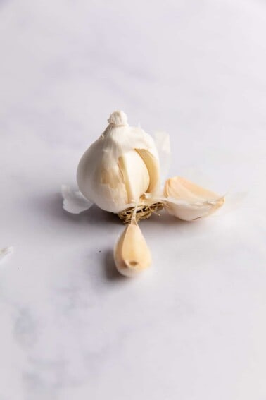 Garlic bulb split apart showing individual cloves.
