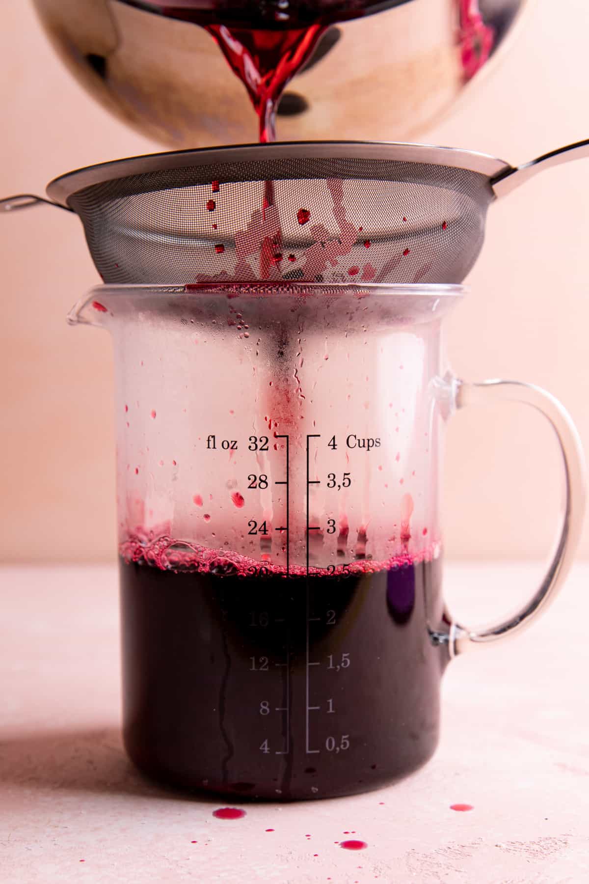 Straining hibiscus flowers from making hibiscus tea.