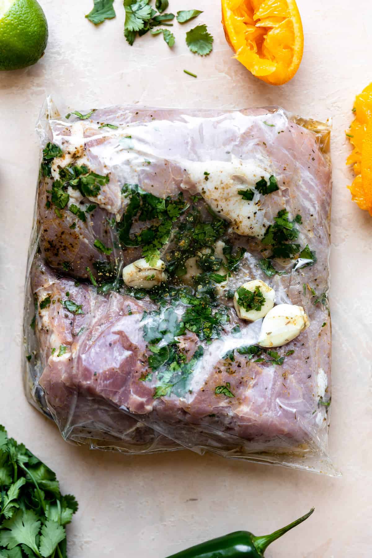 Pork shoulder in a large bag with carnitas marinade.