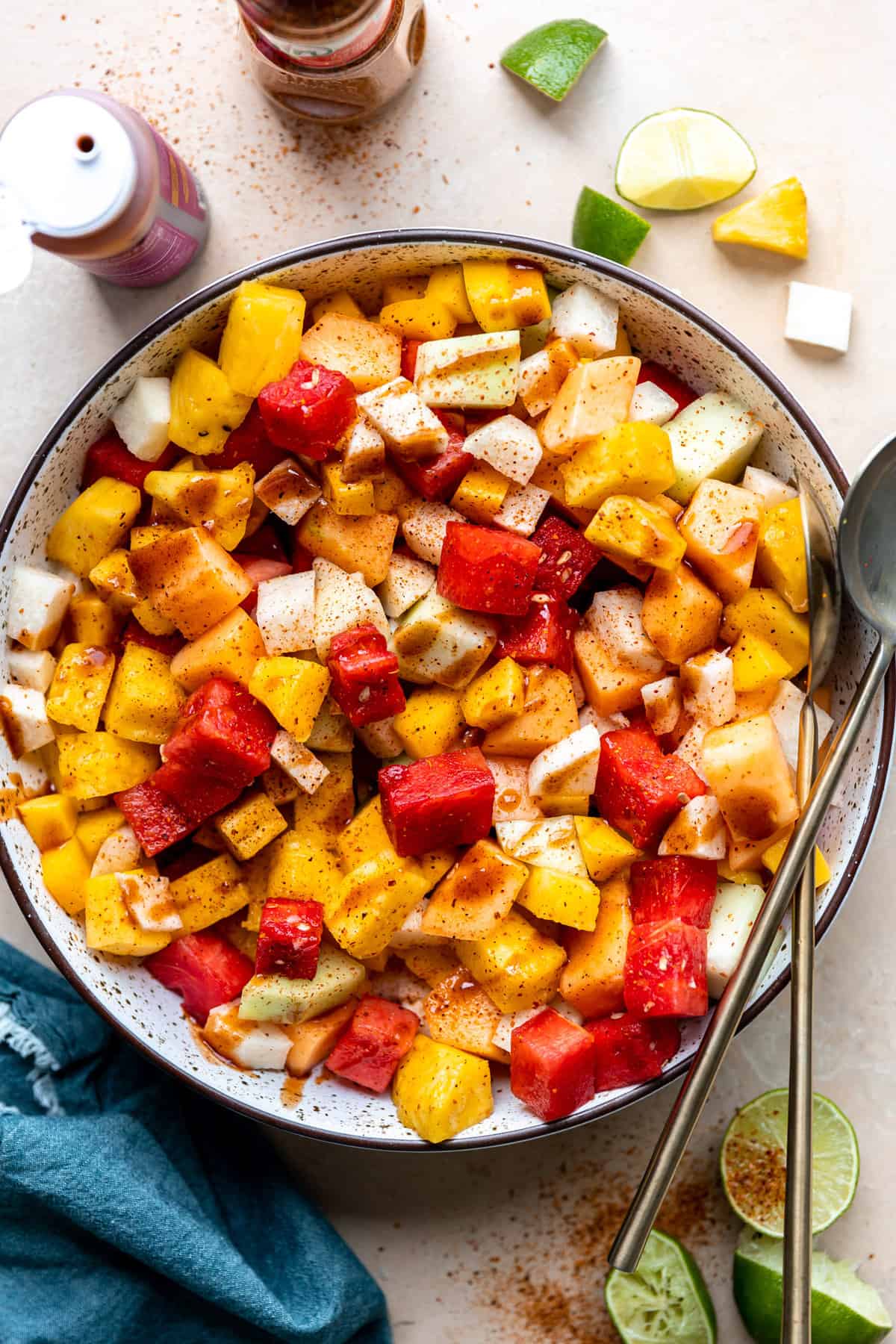 Bowl filled with mexican fruits, topped with tajin and drizzled with chamoy.