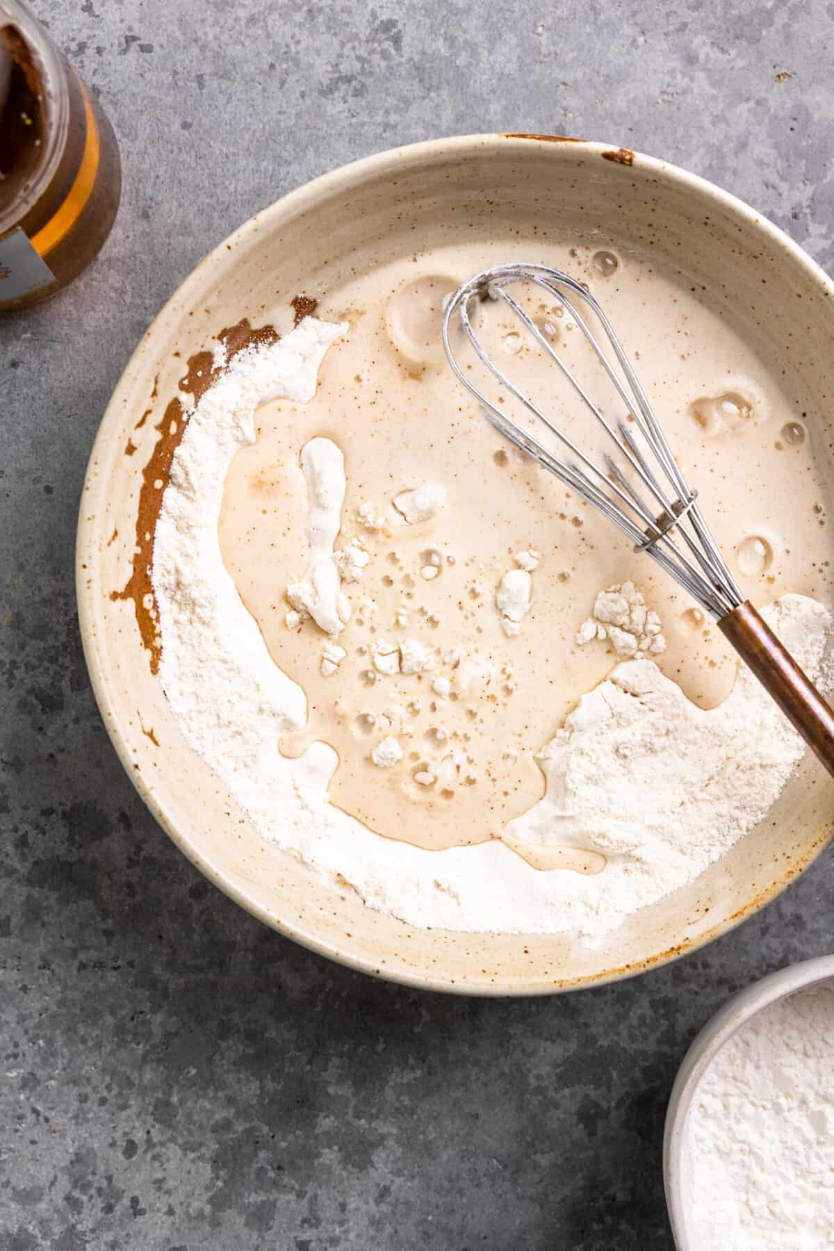 Beer poured into a bowl of dry ingredients to create beer batter. 