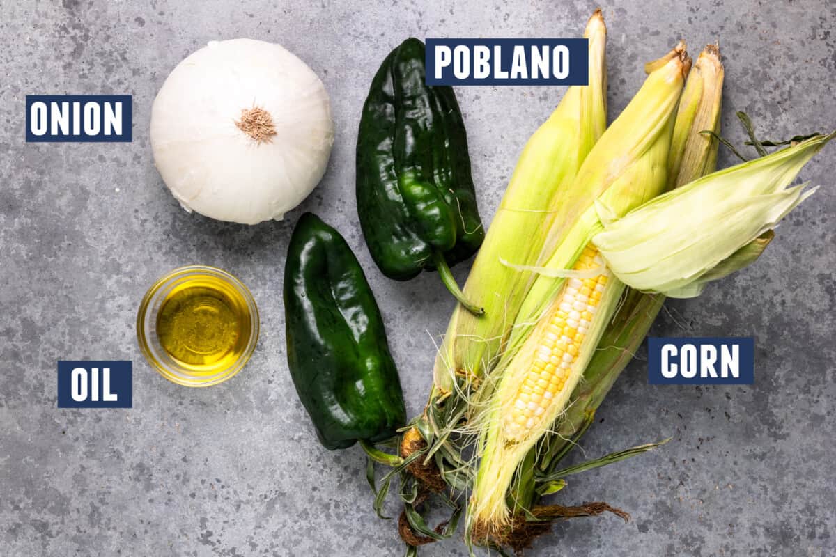 Ingredients needed to grill vegetables for a salad laid out on the counter. 