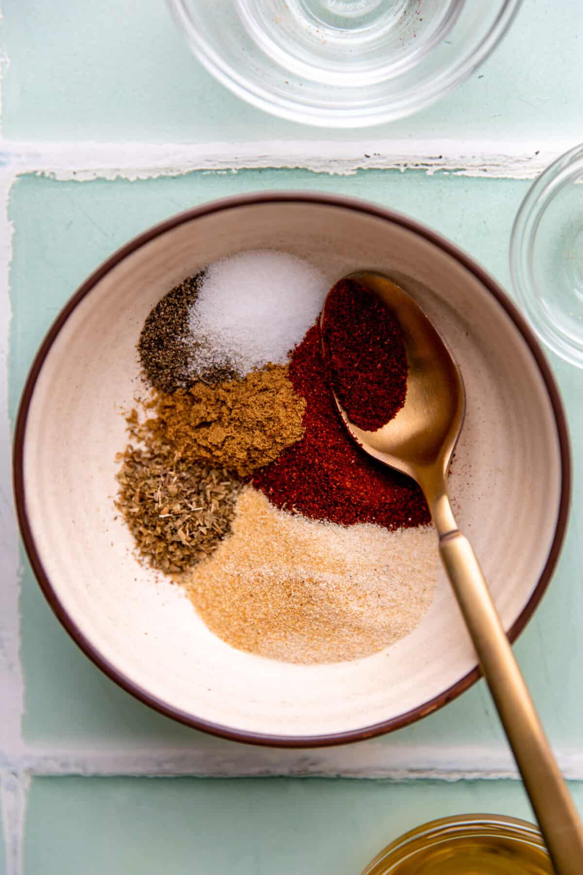 Bowl with spices for a chicken taco seasoning.