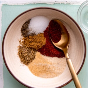 Bowl with spices for a chicken taco seasoning.