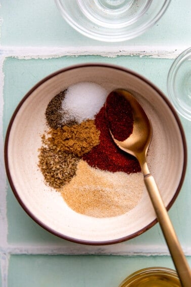 Bowl with spices for a chicken taco seasoning.