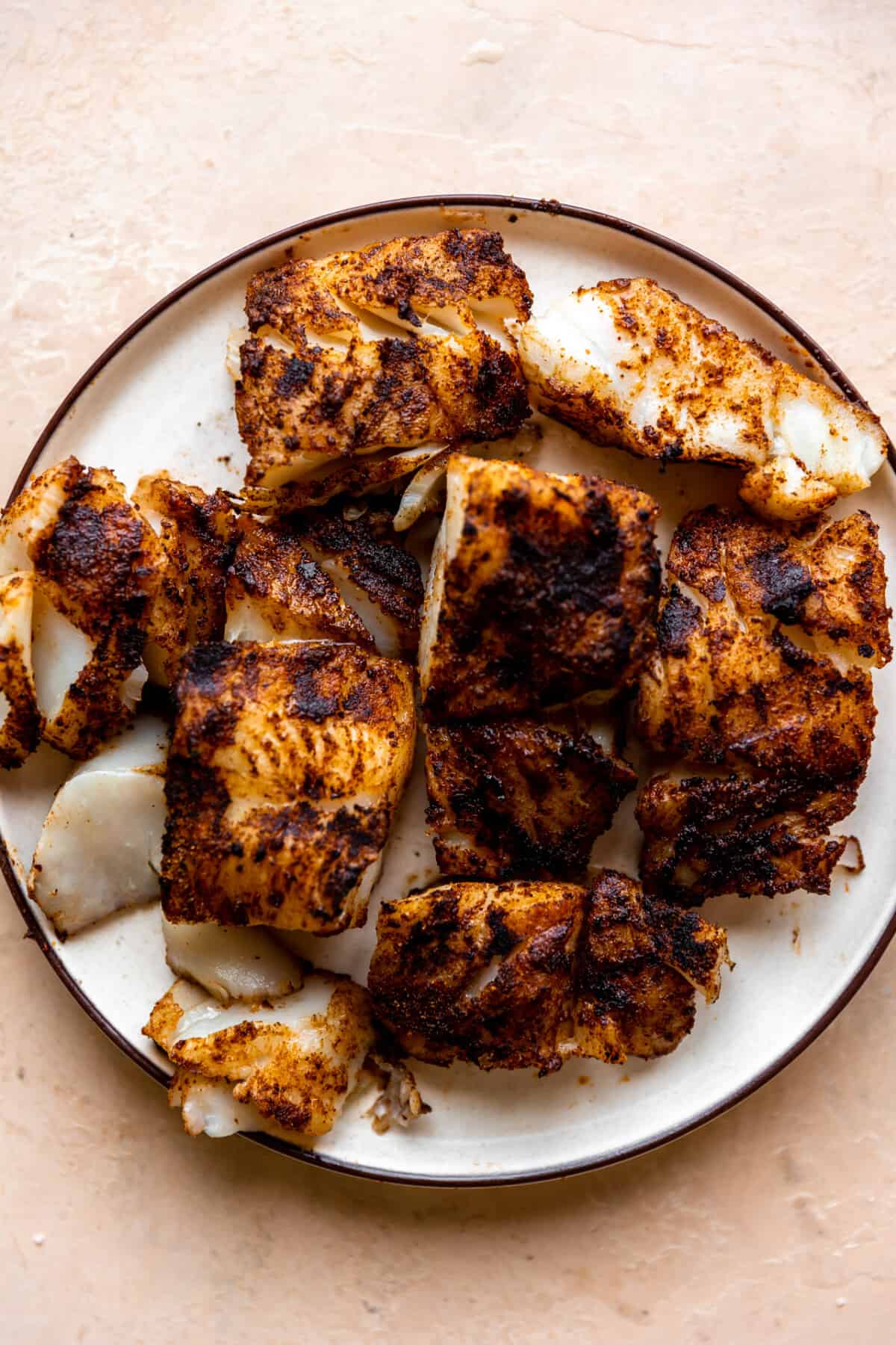 Grilled fish on a white plate. 