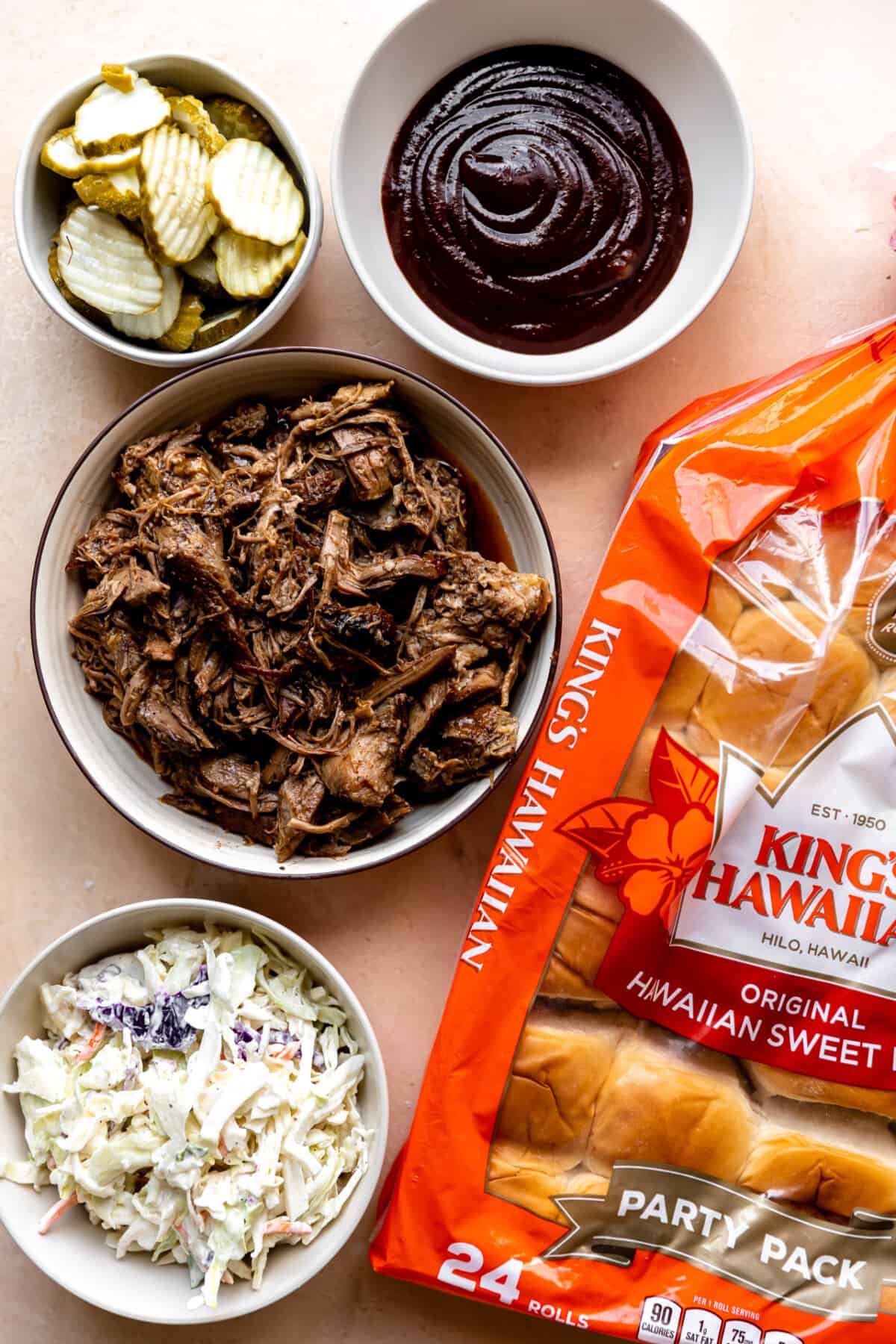 Ingredients needed to make pulled pork sliders laid on the counter. 