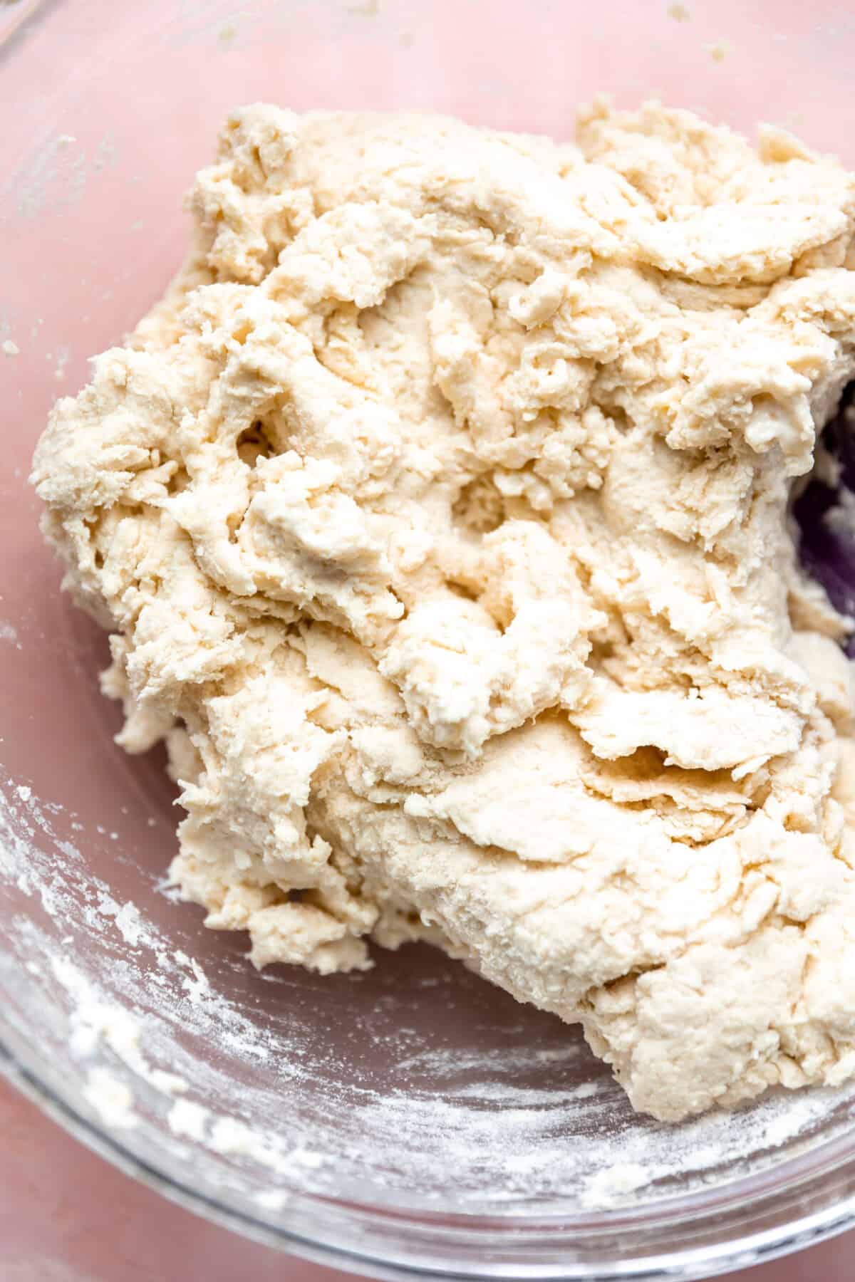 Biscuit dough in a glass bowl.