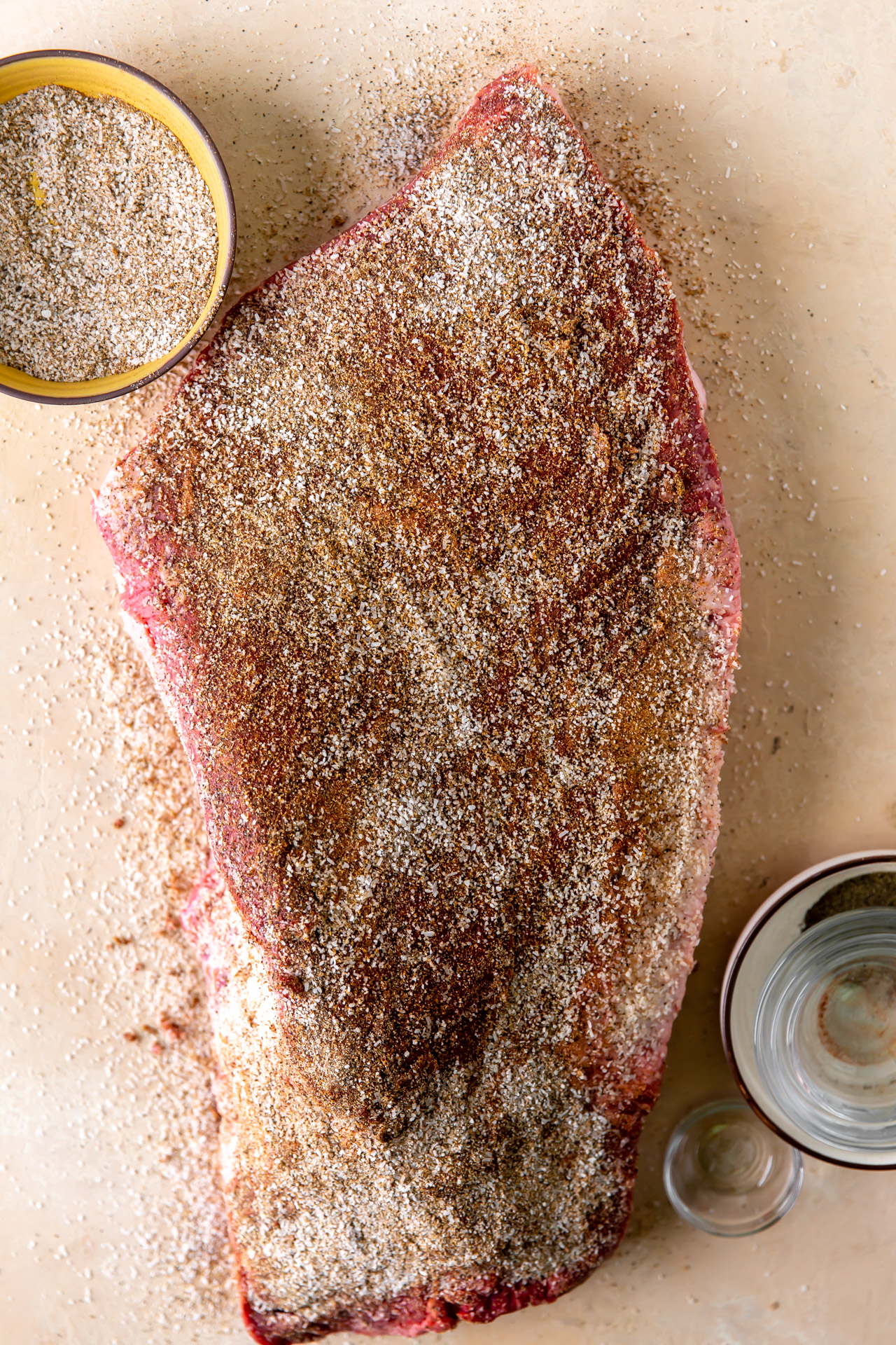 Brisket sprinkled with a brisket dry rub seasoning.