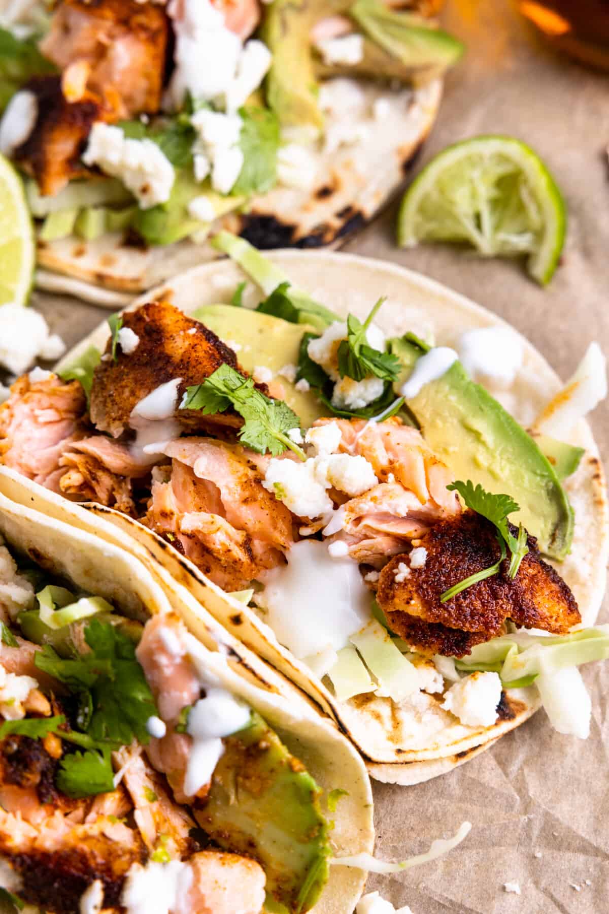 Salmon taos served with cabbage, avocado, crema and crumbled queso fresco. 
