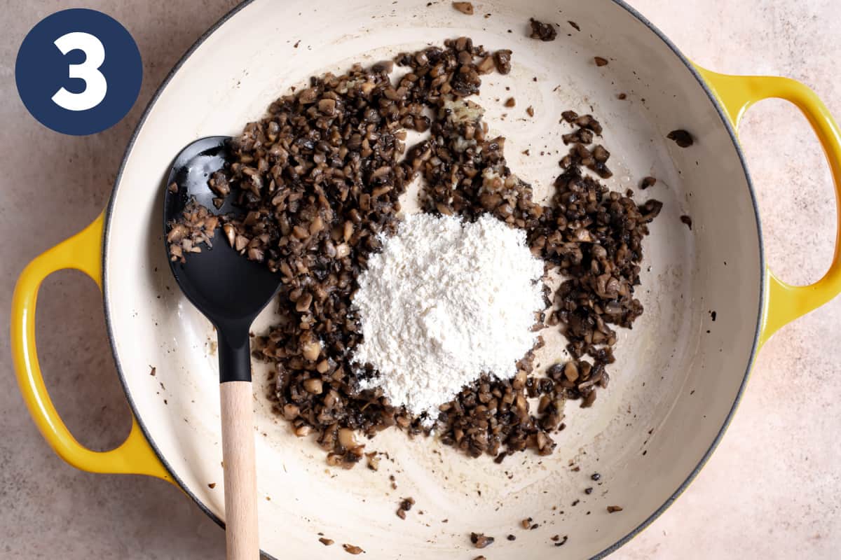 Flour being added to cooked, diced mushrooms.
