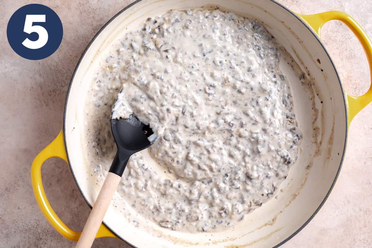 Homemade cream of mushroom soup in a skillet.