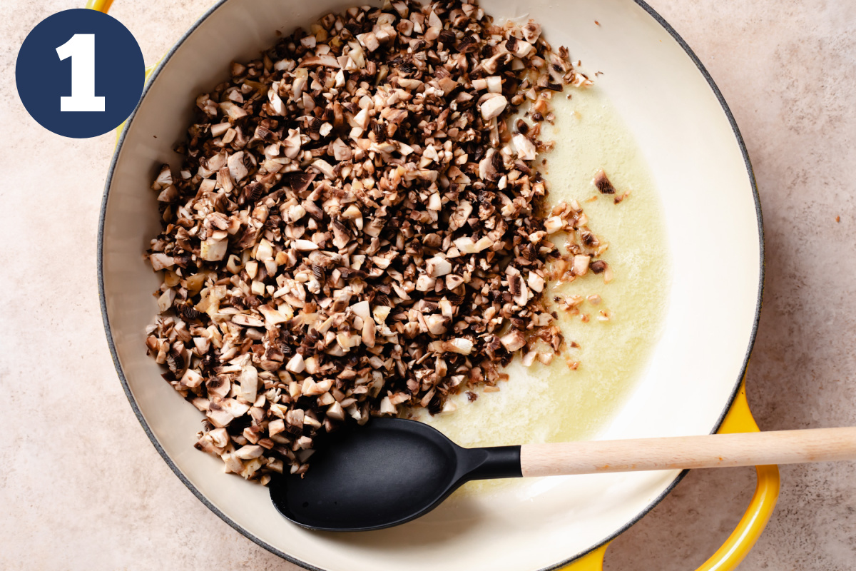 Diced mushrooms in a skillet with butter. 