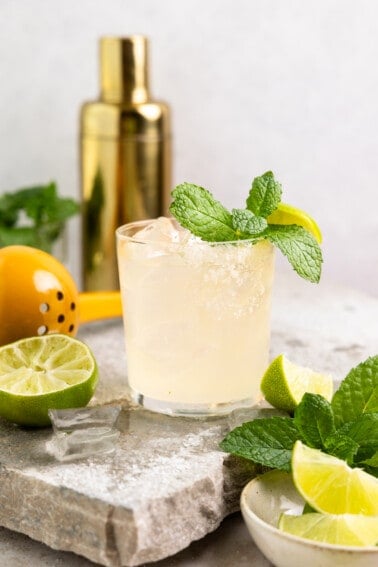 Glass filled with margarita and garnished with mint leaves.