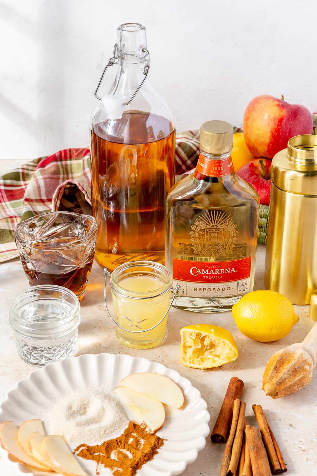 Ingredients needed to make an apple cider margarita on the counter. 