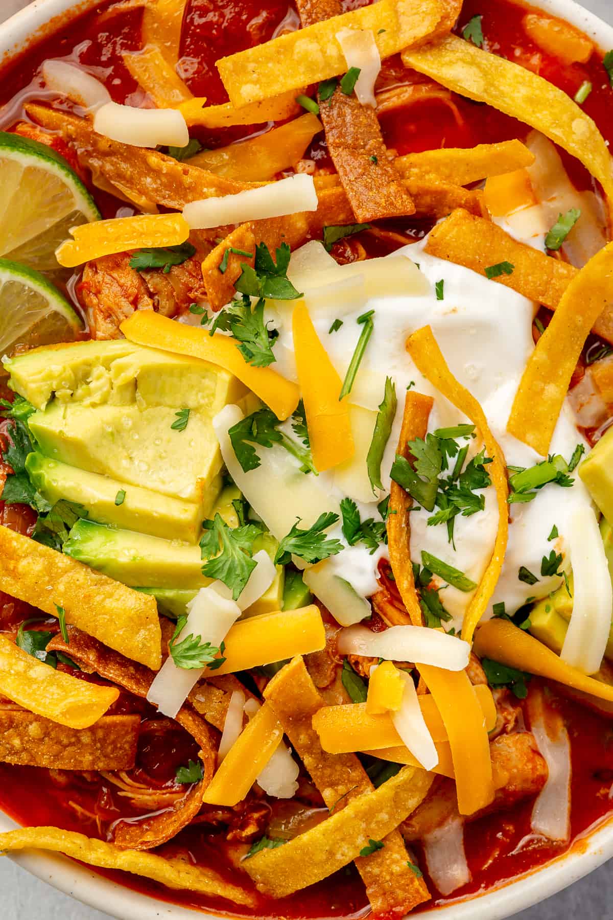 Up close of tortilla soup with toppings. 
