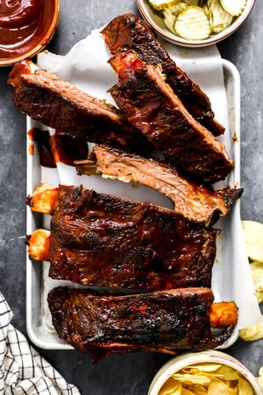 White plate serving beef ribs cooked in the oven.