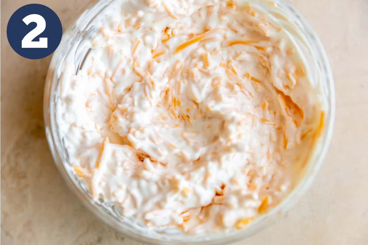 Bowl of sour cream, mayonnaise and cheese mixed together for John Wayne Casserole.