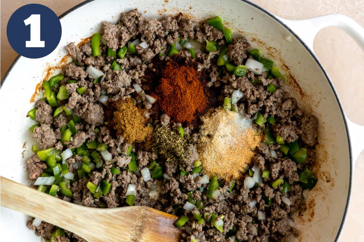 Skillet with ground beef, onion, bell pepper and spices. 