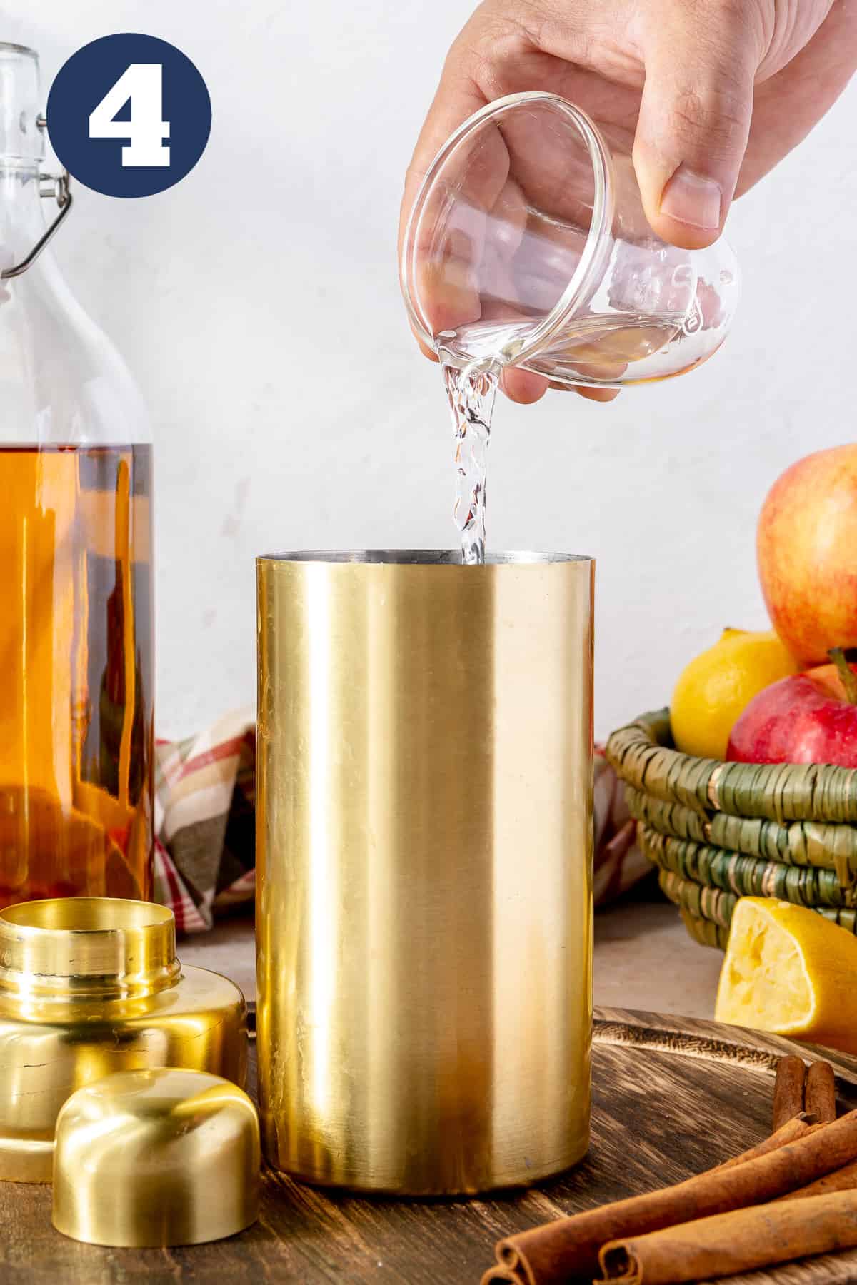 Tequila pouring into a cocktail shaker. 