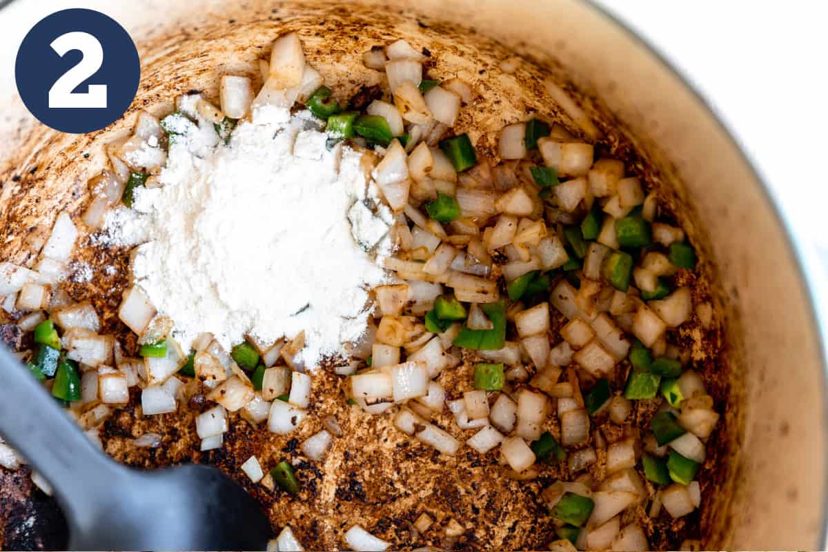 Sautéing onion and jalapeno in a dutch oven, flour being added. 