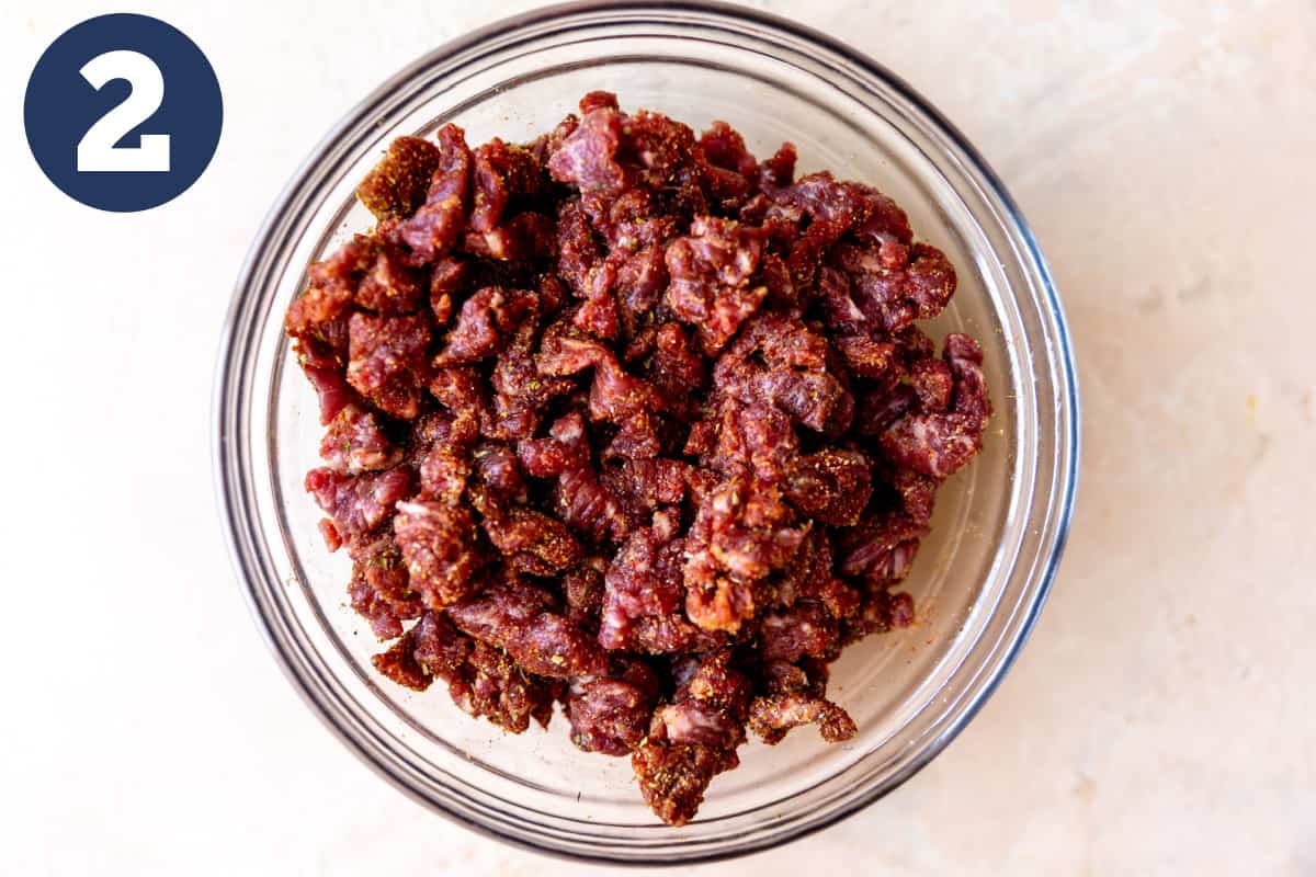 Bowl of minced chuck roast tossed with a spice blend.