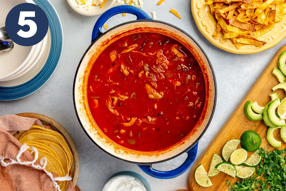 Dutch oven filled with chicken tortilla soup. 