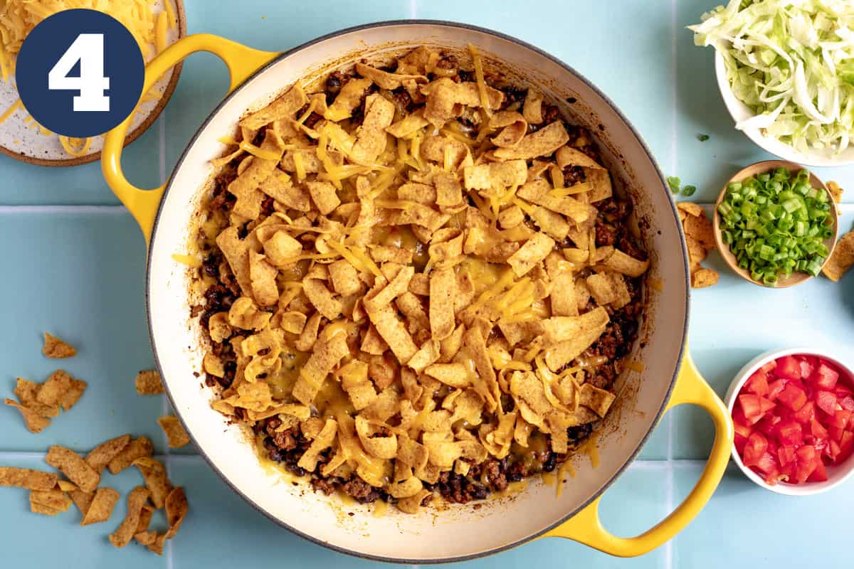 Baked walking taco casserole with topping options on the side. 