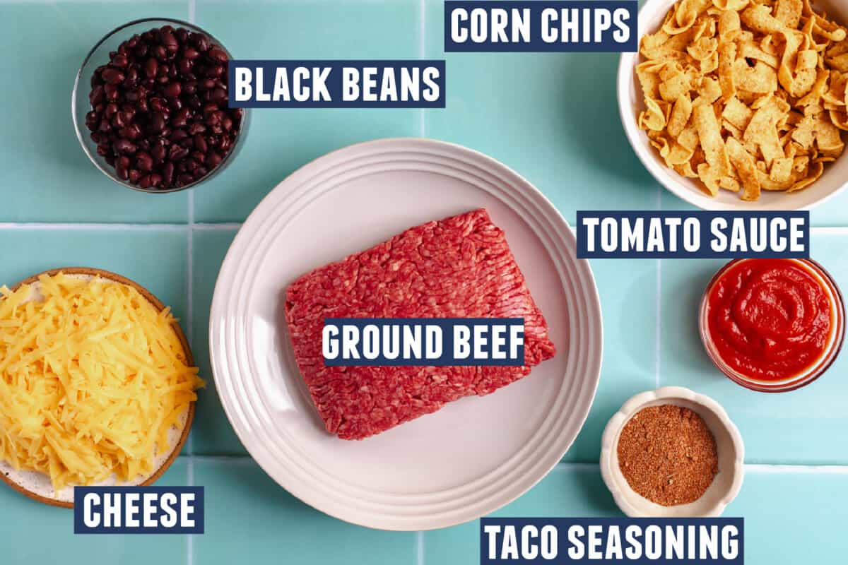 Ingredients needed to make a walking taco casserole laid out on the counter. 