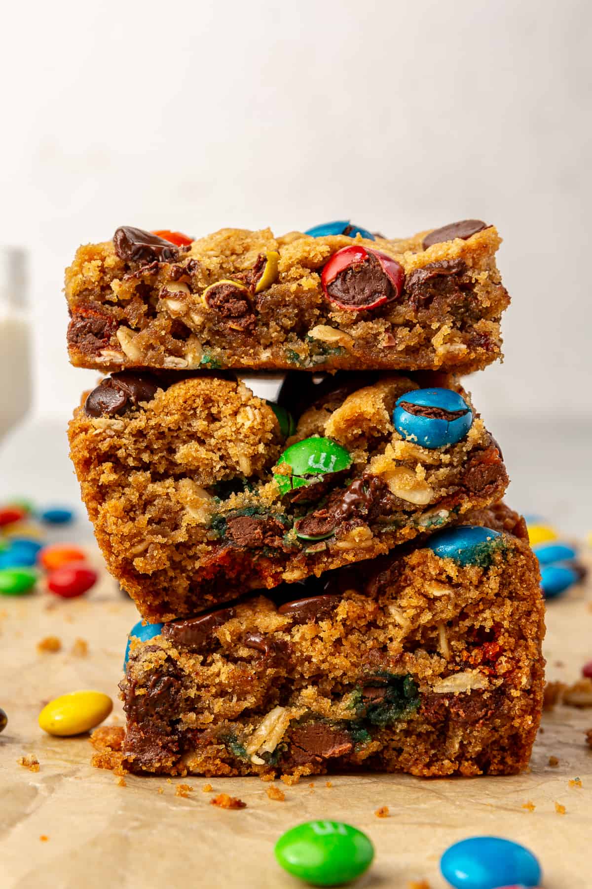 Stack of monster cookie bars with chocolate candies and chocolate chips. 
