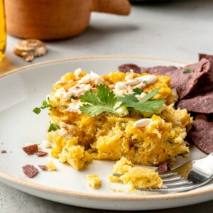 Square of Mexican corn casserole served on a plate.