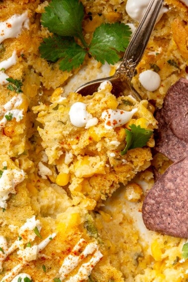 Spoon scooping up mexican corn casserole.