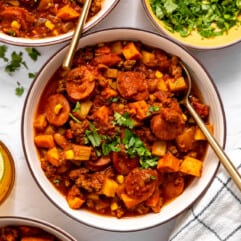 Bowls served with cowboy stew and topped with fresh parsley.