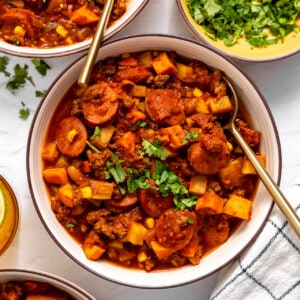 Bowls served with cowboy stew and topped with fresh parsley.