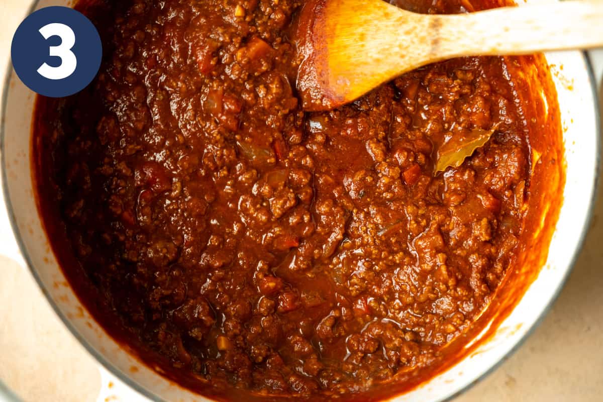 Dutch oven with cooked chili without beans made with ground beef. 