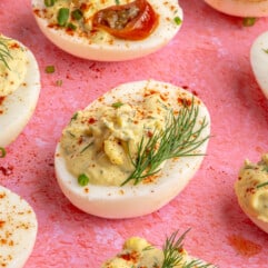 Jalapeño deviled eggs garnished with fresh herbs.