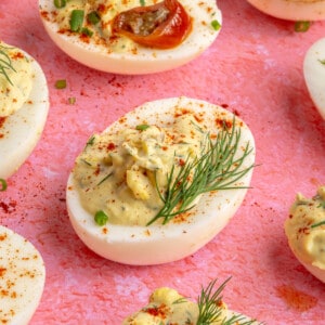 Jalapeño deviled eggs garnished with fresh herbs.