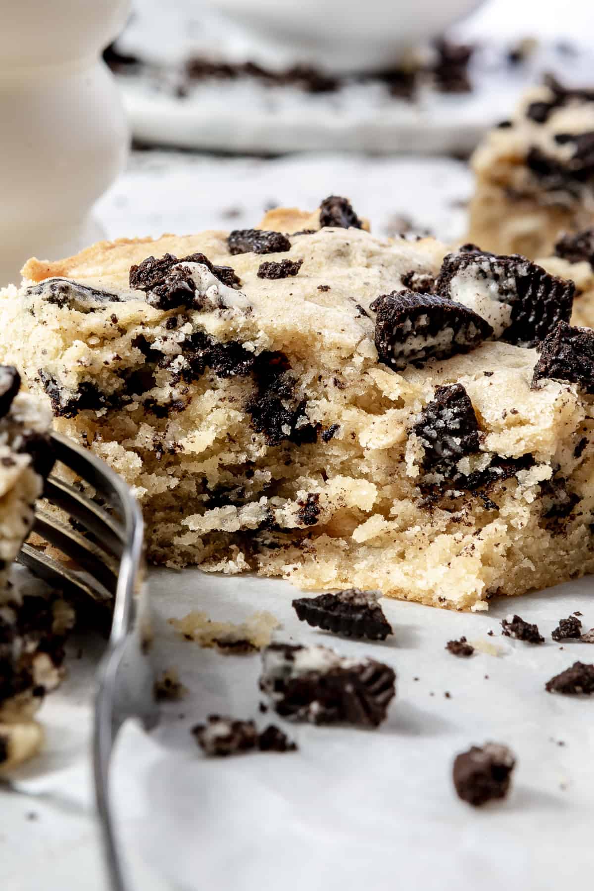 Slice of Oreo bar with a fork serving a bite. 