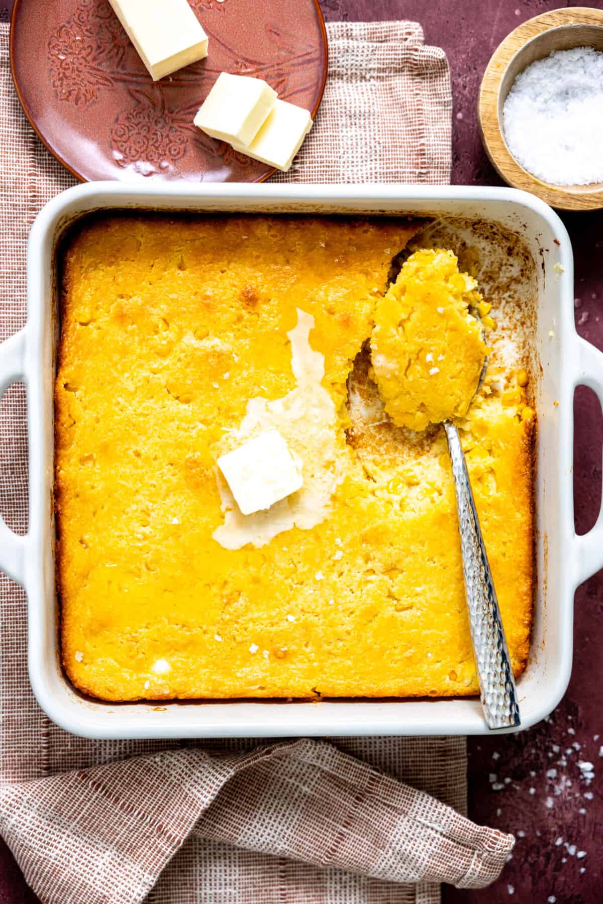 White baking dish with cornbread pudding. 