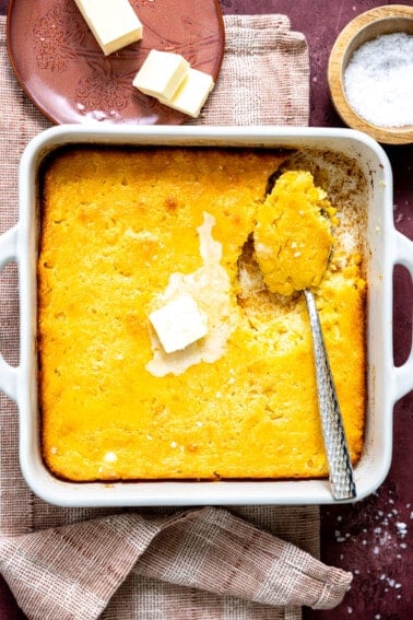 White baking dish with cornbread pudding.