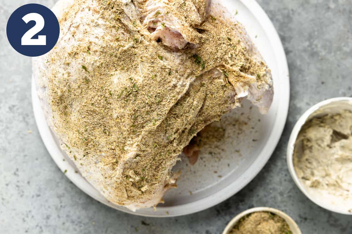 Turkey breast coated with butter and sprinkled with dry rub.